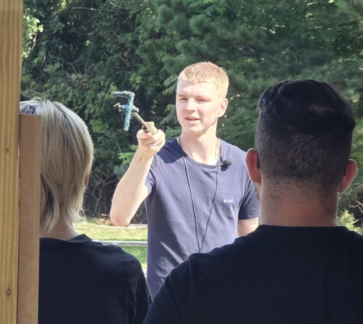 Jonah showing guests how we rand sheep